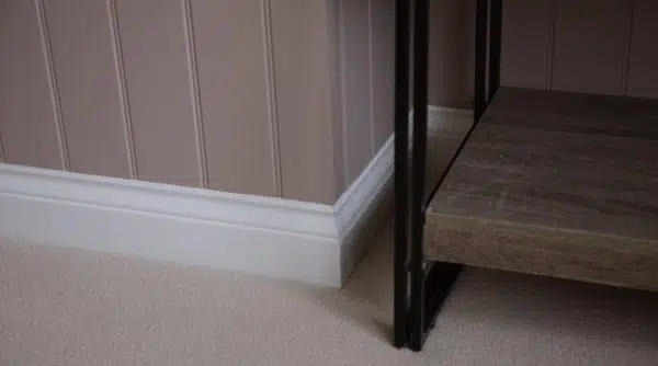 Soft red wall panelling with skirting on corner