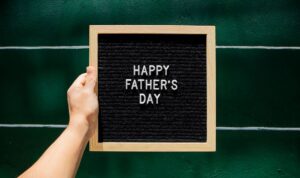 Happy Father's Day message in front of a green wall